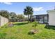 Large backyard with a fenced pool, mature trees, and well-maintained landscaping at 621 Avocado St, St Cloud, FL 34769
