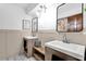 Stylish bathroom with dual sinks, modern fixtures, beautiful mirrors, and a convenient bench at 621 Avocado St, St Cloud, FL 34769