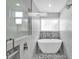 Bright bathroom with shower, stand-alone tub, modern finishes, and elegant tiling at 621 Avocado St, St Cloud, FL 34769