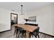 Bright dining room featuring a wooden table with black chairs, a modern light fixture, and wood-look floors at 621 Avocado St, St Cloud, FL 34769
