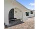 Welcoming front entrance with an arched doorway and a brick-paved patio leading to the front door at 621 Avocado St, St Cloud, FL 34769