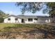 Charming single-story home featuring a well-manicured front yard and a two-car garage at 621 Avocado St, St Cloud, FL 34769