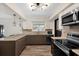 Bright kitchen with stainless steel appliances, modern lighting, and ample countertop space at 621 Avocado St, St Cloud, FL 34769