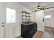 Well-lit laundry room with front loading washer and dryer, shelving, and sliding barn door at 621 Avocado St, St Cloud, FL 34769