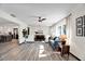 Spacious living area featuring wood-look floors, a comfortable sofa, and an adjacent dining area at 621 Avocado St, St Cloud, FL 34769