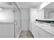 Sleek main bathroom with marble counters, dual sinks, and a glass-enclosed shower at 621 Avocado St, St Cloud, FL 34769