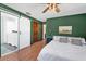 Stylish main bedroom with ensuite bathroom featuring a sliding barn door and hardwood floors at 621 Avocado St, St Cloud, FL 34769
