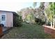 Spacious backyard featuring lush greenery, mature landscaping, and a storage shed at 10 Massachusetts Ave, St Cloud, FL 34769