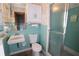 Bathroom features a blue tile shower, toilet, and sink at 10 Massachusetts Ave, St Cloud, FL 34769