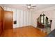 Cozy bedroom with hardwood floors, accent wallpaper, and view into sunroom, creating a relaxing and inviting space at 10 Massachusetts Ave, St Cloud, FL 34769