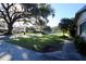 Expansive front yard with mature trees and lush lawn in a desirable neighborhood setting at 10 Massachusetts Ave, St Cloud, FL 34769