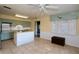 Well-lit kitchen area with stainless steel appliances, tiled countertops, custom cabinets, and lots of natural light at 10 Massachusetts Ave, St Cloud, FL 34769