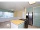 Bright kitchen with stainless steel appliances, tiled countertops, custom cabinetry, and lots of natural light at 10 Massachusetts Ave, St Cloud, FL 34769