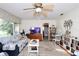 Bright living room with a ceiling fan and access to the kitchen at 10 Massachusetts Ave, St Cloud, FL 34769