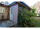 Charming side of the house features a secluded entrance and mature landscaping at 10 Massachusetts Ave, St Cloud, FL 34769
