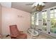 Cozy sunroom with a ceiling fan, chair, and backyard view at 10 Massachusetts Ave, St Cloud, FL 34769
