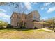 Two-story home with a well-manicured lawn and an attached two-car garage at 10368 Stone Glen Dr, Orlando, FL 32825