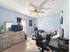 Inviting bedroom with light blue walls, ceiling fan, and natural light from the window at 1228 Haines Dr, Winter Haven, FL 33881