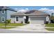 Well-maintained home with a manicured lawn, two-car garage, and solar panels at 1228 Haines Dr, Winter Haven, FL 33881