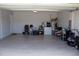 This is a spacious garage with a light gray tiled floor and gray walls with garage items staged neatly around the perimeter at 1228 Haines Dr, Winter Haven, FL 33881