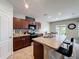 Open kitchen featuring granite countertops, dark wood cabinets and stainless steel appliances at 1228 Haines Dr, Winter Haven, FL 33881