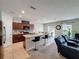 Open-concept kitchen with cherry wood cabinets, island with bar seating and stainless steel appliances at 1228 Haines Dr, Winter Haven, FL 33881