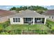 Aerial view of backyard with green lawn, black fence and screened patio area with furniture, perfect for relaxing at 1264 Bonita Canyon Dr, Kissimmee, FL 34759