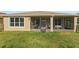 View of back porch, with screened enclosures and open lawn area at 1264 Bonita Canyon Dr, Kissimmee, FL 34759