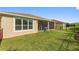 Home exterior showcasing well-kept lawn and screened-in patio offering a peaceful retreat in a private backyard at 1264 Bonita Canyon Dr, Kissimmee, FL 34759