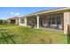 Lovely backyard with a well-maintained lawn and a screened-in patio for enjoying the outdoors in comfort at 1264 Bonita Canyon Dr, Kissimmee, FL 34759