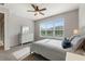 Bright bedroom featuring a ceiling fan, large window, and neutral décor at 1264 Bonita Canyon Dr, Kissimmee, FL 34759