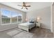 Comfortable bedroom with large window, ceiling fan, and neutral carpet at 1264 Bonita Canyon Dr, Kissimmee, FL 34759