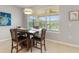 Cozy dining area with natural light, a modern light fixture, and outdoor views at 1264 Bonita Canyon Dr, Kissimmee, FL 34759