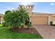 Charming single-Gathering home featuring a well-manicured lawn and a two-car garage with brick paver driveway at 1264 Bonita Canyon Dr, Kissimmee, FL 34759