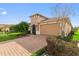 Beautiful home showcasing a brick paver driveway, a two-car garage and landscaped flower beds at 1264 Bonita Canyon Dr, Kissimmee, FL 34759