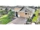 Charming front exterior with well-manicured landscaping, a brick driveway, and a two-car garage for convenience at 1264 Bonita Canyon Dr, Kissimmee, FL 34759