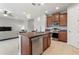 Modern kitchen with stainless steel appliances and granite countertops, adjacent to living room at 1264 Bonita Canyon Dr, Kissimmee, FL 34759