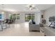 Spacious living area with tile flooring, neutral paint and a view of the screened patio at 1264 Bonita Canyon Dr, Kissimmee, FL 34759