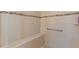Accessible shower featuring tiled walls, a built-in bench, and grab bar at 1264 Bonita Canyon Dr, Kissimmee, FL 34759