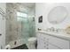 Well-lit bathroom features modern vanity, glass shower door, and neutral color palette at 13049 Sunshine Cir, Clermont, FL 34711