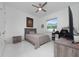 Bedroom features light grey and white color scheme, modern furnishings, and natural light at 13049 Sunshine Cir, Clermont, FL 34711