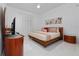 Bedroom with hardwood bed frame, ceiling fan, and natural light at 13049 Sunshine Cir, Clermont, FL 34711