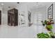 Elegant foyer boasts high ceilings, modern lighting, and crisp white tile flooring at 13049 Sunshine Cir, Clermont, FL 34711