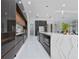 Modern kitchen with glossy cabinets, a large center island, and stainless-steel appliances for cooking and entertaining at 13049 Sunshine Cir, Clermont, FL 34711