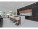 Sleek, modern kitchen featuring a large island with seating, glossy cabinets, and stylish pendant lighting at 13049 Sunshine Cir, Clermont, FL 34711