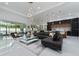 Open-concept living area featuring modern furnishings, elegant lighting, and glossy tile floors at 13049 Sunshine Cir, Clermont, FL 34711
