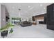 Bright, open-concept living space featuring sleek tile flooring, modern furnishings, and natural light at 13049 Sunshine Cir, Clermont, FL 34711