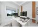 Bright, modern home office with a sleek white desk, contemporary decor, and a scenic window view at 13049 Sunshine Cir, Clermont, FL 34711
