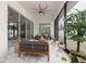 Enclosed patio with marble floors, ceiling fan, and sliding glass doors to blend indoor and outdoor living at 13049 Sunshine Cir, Clermont, FL 34711