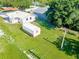 An aerial view showcasing the property's backyard and surrounding neighborhood at 1418 Delaware Ave, St Cloud, FL 34769